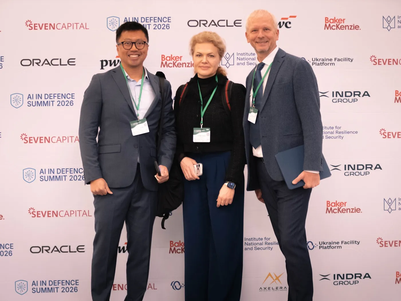 Attendees in front of the 2026 summit photo wall