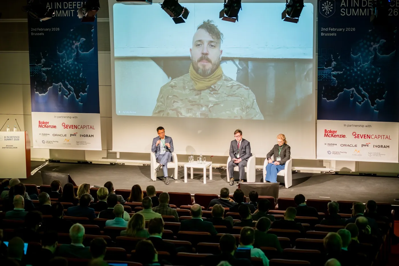 Panel on stage with a remote speaker on the main screen
