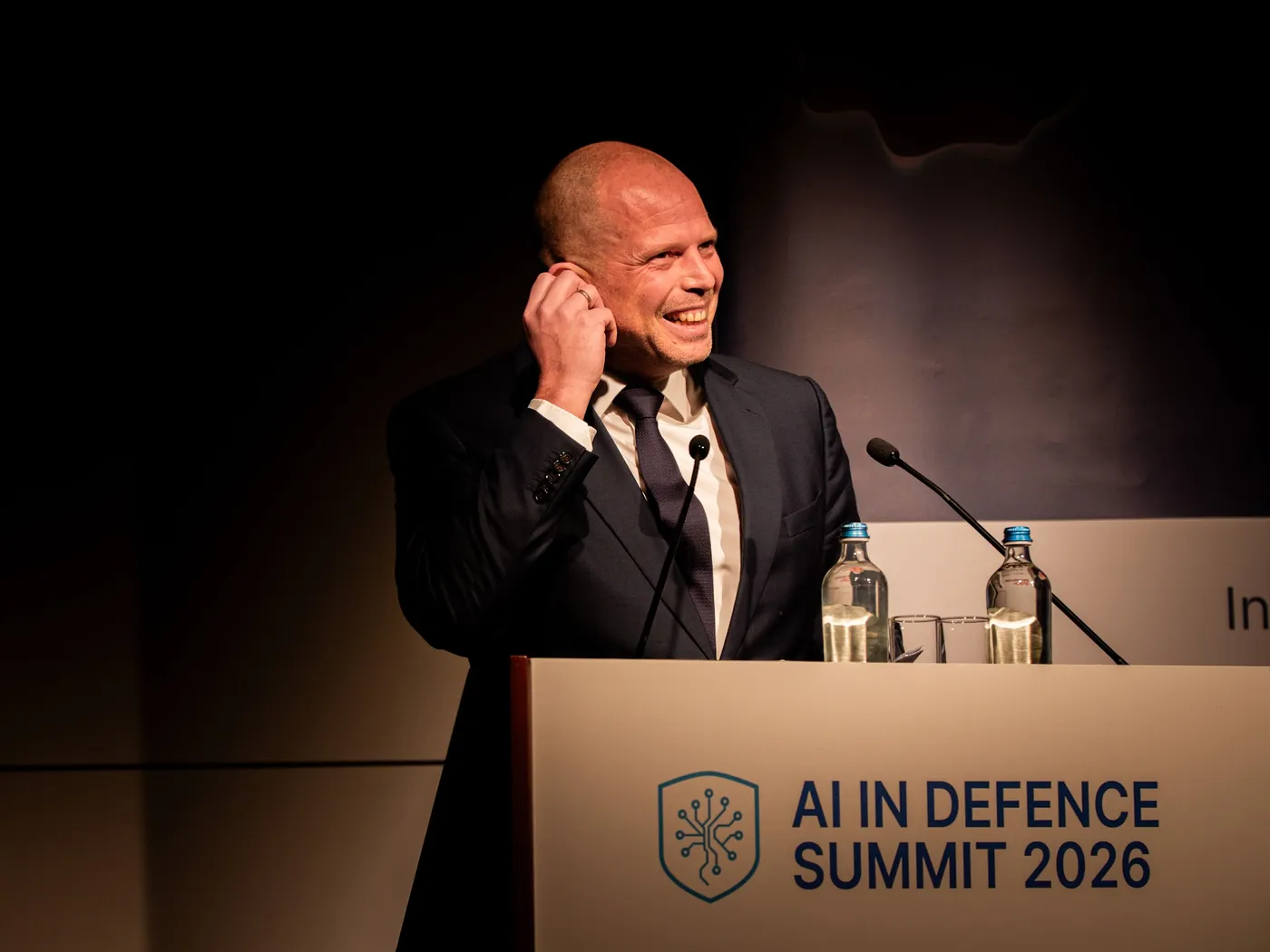 Speaker smiling at the podium at the 2026 summit